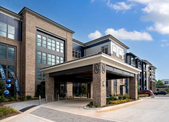 an office building with an entrance and awning on the side of a street at Preston Ridge, Cary, NC, 27513
